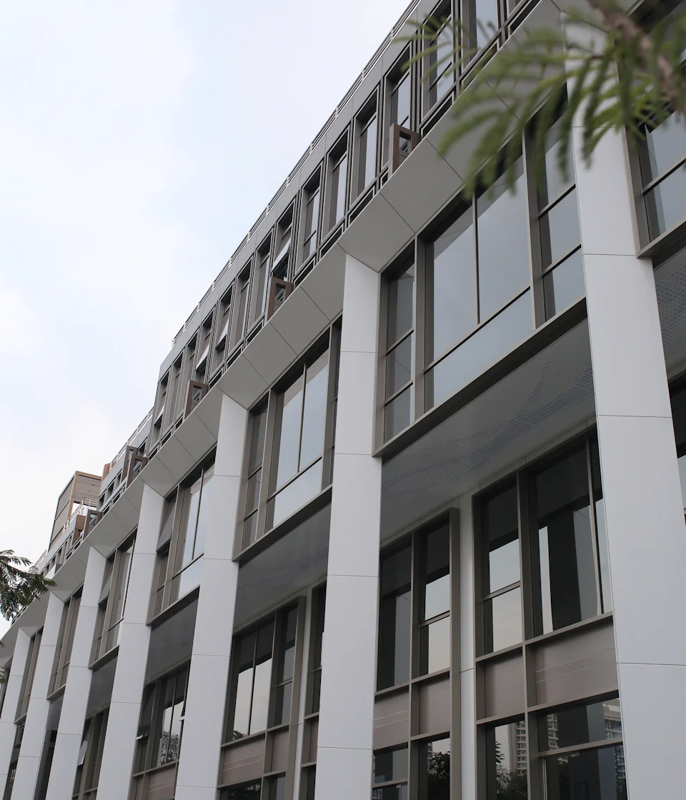 Modern commercial building with glass façades and landscaped surroundings